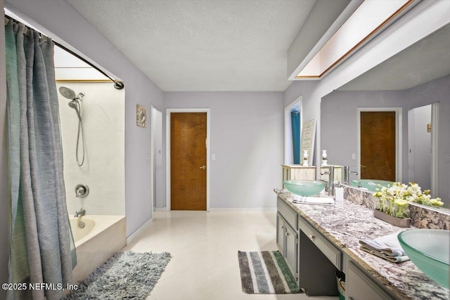1216 Radis Pl, Jacksonville, FL 32225 - bathroom featuring double vanity, a textured ceiling, a sink, and shower / bath combo with shower curtain