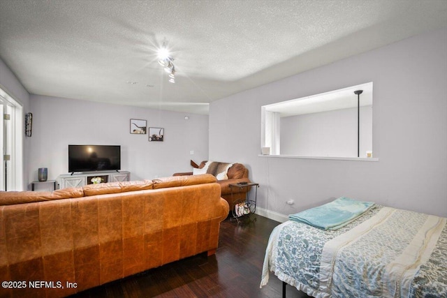 1216 Radis Pl, Jacksonville, FL 32225 - bedroom with baseboards, a textured ceiling, and wood finished floors