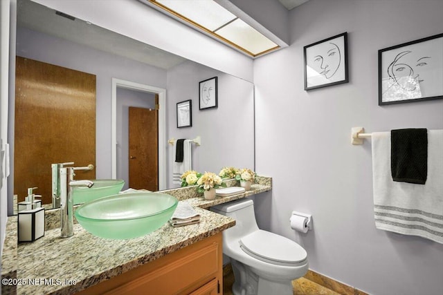 1216 Radis Pl, Jacksonville, FL 32225 - bathroom featuring baseboards, toilet, and vanity