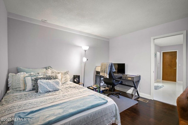 1216 Radis Pl, Jacksonville, FL 32225 - bedroom featuring a textured ceiling, baseboards, and wood finished floors