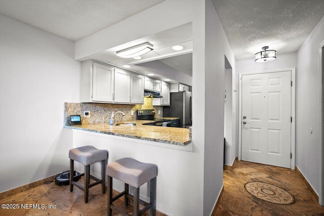 1216 Radis Pl, Jacksonville, FL 32225 - kitchen with a sink, range hood, backsplash, appliances with stainless steel finishes, and a textured ceiling