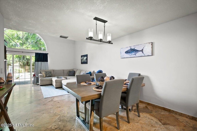 1216 Radis Pl, Jacksonville, FL 32225 - dining space featuring stone finish flooring, baseboards, a textured ceiling, and visible vents