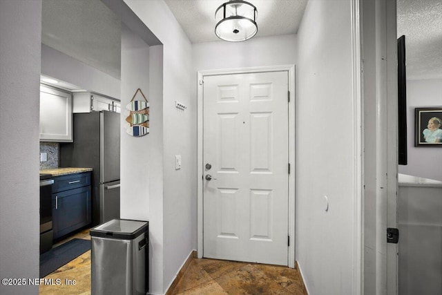 1216 Radis Pl, Jacksonville, FL 32225 - entryway featuring baseboards and a textured ceiling