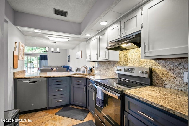 1216 Radis Pl, Jacksonville, FL 32225 - kitchen featuring a sink, appliances with stainless steel finishes, under cabinet range hood, visible vents, and decorative backsplash