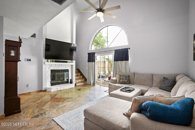 1216 Radis Pl, Jacksonville, FL 32225 - living room with a textured ceiling, high vaulted ceiling, stone finish flooring, a ceiling fan, and a stone fireplace