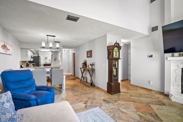 1216 Radis Pl, Jacksonville, FL 32225 - living area with baseboards, a fireplace, visible vents, and stone finish floor