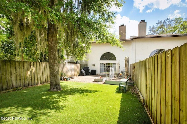 1216 Radis Pl, Jacksonville, FL 32225 - rear view of house featuring a fenced backyard, a chimney, stucco siding, and a yard