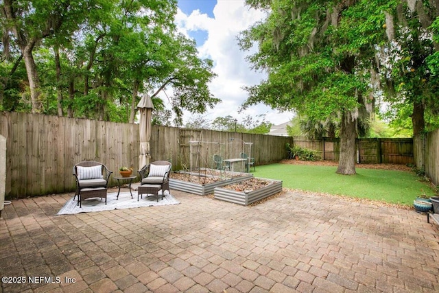 1216 Radis Pl, Jacksonville, FL 32225 - view of patio featuring a fenced backyard and a vegetable garden