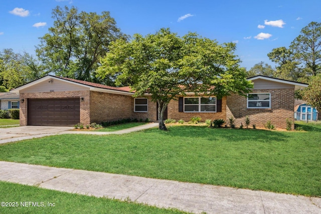 single story home with brick siding, a front lawn, concrete driveway, and an attached garage