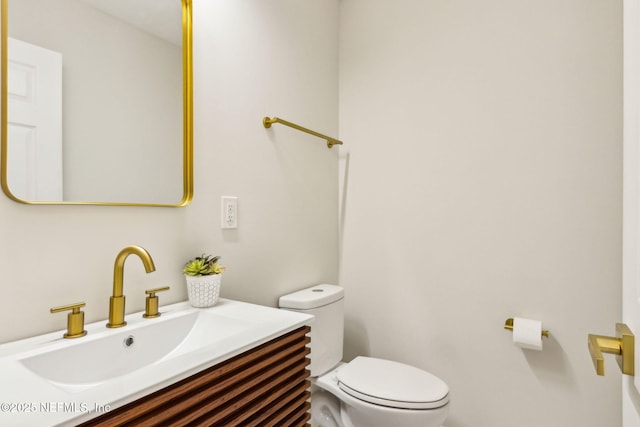 bathroom with toilet and vanity