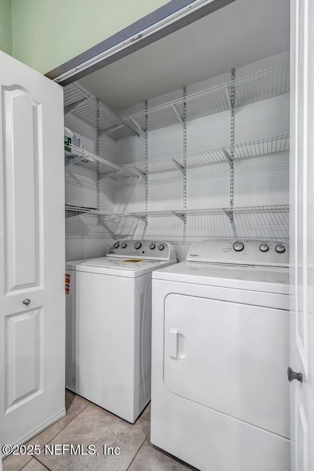 234 Aralia Ln, Jacksonville, FL 32216 - clothes washing area with separate washer and dryer and light tile patterned flooring