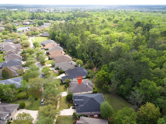 birds eye view of property with a wooded view and a residential view