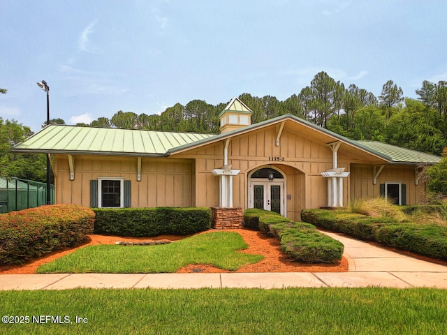 view of front of home with french doors, metal roof, and a standing seam roof