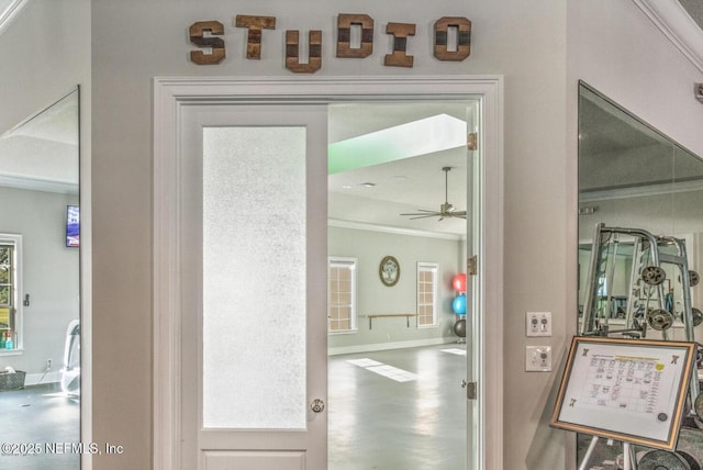 interior space featuring baseboards and crown molding