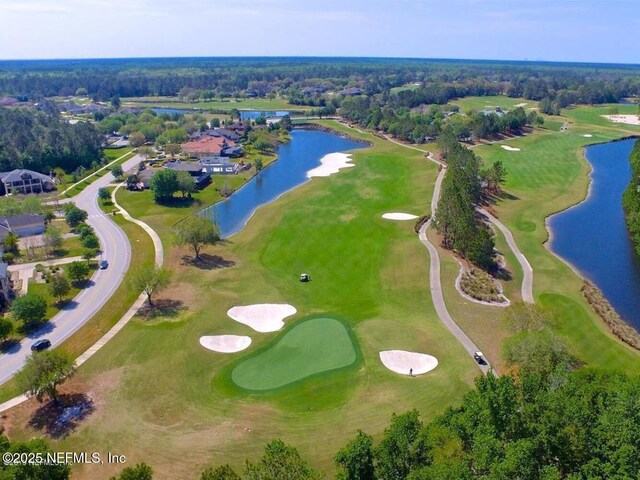 bird's eye view featuring a water view and view of golf course