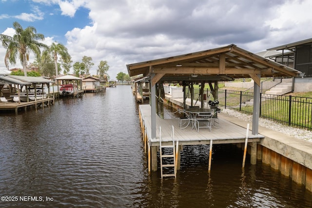 111 Magnolia Dr, East Palatka, FL 32131 - view of dock featuring boat lift, a water view, and fence