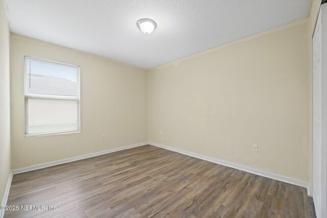 1832 Navaho Ave, Jacksonville, FL 32210 - unfurnished room featuring baseboards, wood finished floors, and a textured ceiling