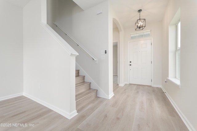 2895 Cross Creek Dr, Green Cove Springs, FL 32043 - entryway with plenty of natural light, a chandelier, arched walkways, and light wood-style floors