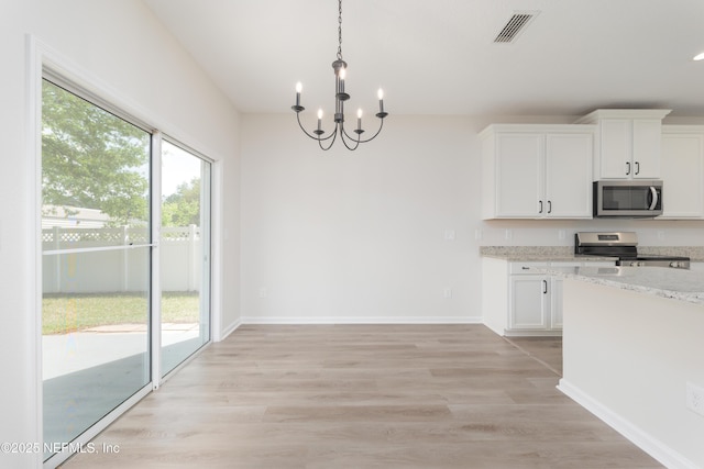 2895 Cross Creek Dr, Green Cove Springs, FL 32043 - kitchen featuring white cabinets, visible vents, a chandelier, stainless steel appliances, and light stone counters