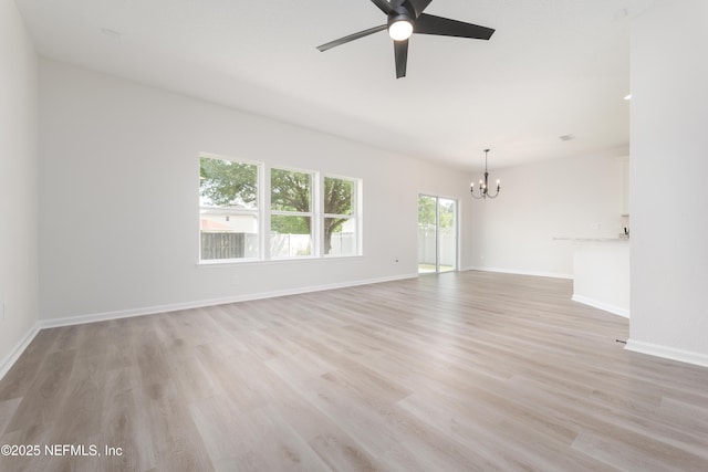 2895 Cross Creek Dr, Green Cove Springs, FL 32043 - empty room featuring ceiling fan with notable chandelier, light wood-type flooring, and baseboards