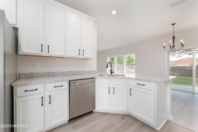 2895 Cross Creek Dr, Green Cove Springs, FL 32043 - kitchen with a notable chandelier, a sink, appliances with stainless steel finishes, a peninsula, and visible vents