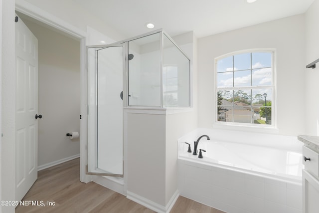 2895 Cross Creek Dr, Green Cove Springs, FL 32043 - full bath featuring a bath, recessed lighting, baseboards, a stall shower, and wood finished floors