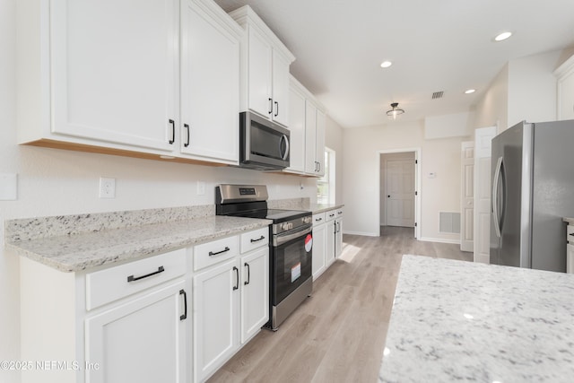 2895 Cross Creek Dr, Green Cove Springs, FL 32043 - kitchen featuring recessed lighting, light wood-style floors, visible vents, white cabinets, and appliances with stainless steel finishes