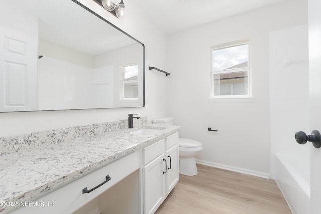 2895 Cross Creek Dr, Green Cove Springs, FL 32043 - bathroom featuring baseboards, wood finished floors, toilet, and vanity