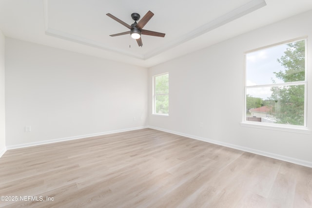 2895 Cross Creek Dr, Green Cove Springs, FL 32043 - empty room with baseboards, light wood-type flooring, ceiling fan, and a raised ceiling