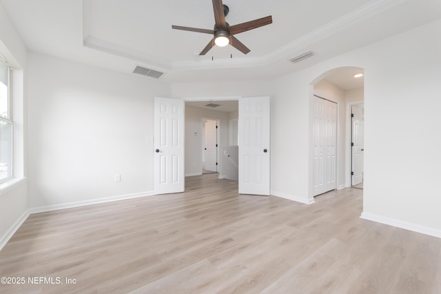 2895 Cross Creek Dr, Green Cove Springs, FL 32043 - unfurnished room with visible vents, baseboards, a ceiling fan, a raised ceiling, and arched walkways