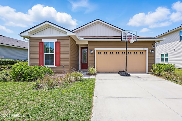 view of front of property with an attached garage, a front lawn, driveway, and board and batten siding
