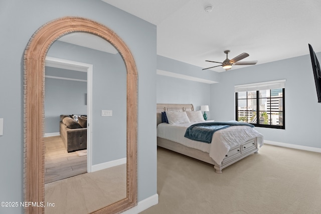 1478 Riverplace Blvd Unit 803, Jacksonville, FL 32207 - carpeted bedroom featuring baseboards, arched walkways, and a ceiling fan