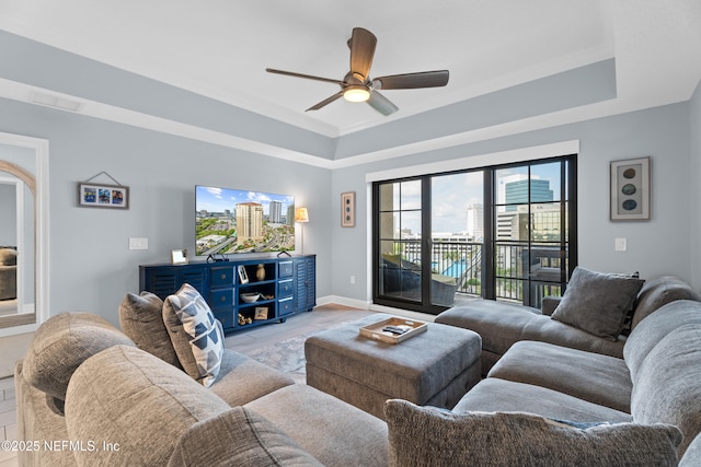 1478 Riverplace Blvd Unit 803, Jacksonville, FL 32207 - living room with baseboards, a ceiling fan, and a raised ceiling