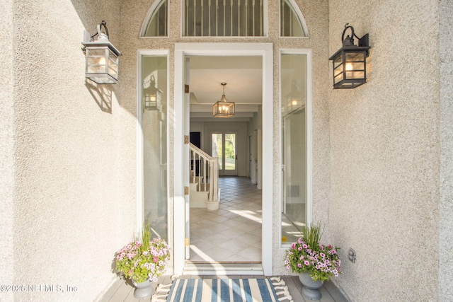 view of exterior entry featuring stucco siding