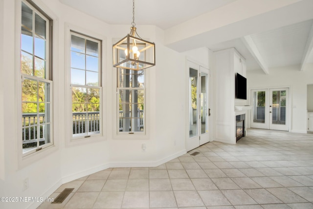 interior space with light tile patterned floors, an inviting chandelier, beamed ceiling, baseboards, and visible vents