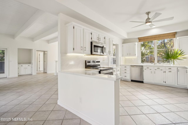 kitchen with stainless steel appliances, a ceiling fan, light countertops, and light tile patterned floors