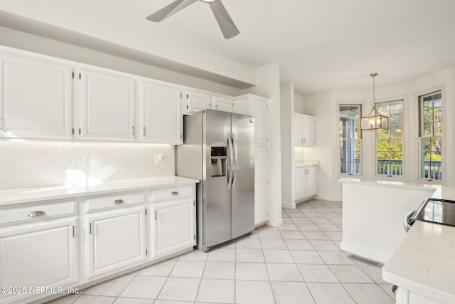 kitchen with white cabinets, stainless steel refrigerator with ice dispenser, visible vents, and light countertops