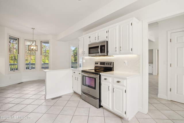 kitchen with light tile patterned flooring, visible vents, an inviting chandelier, light countertops, and appliances with stainless steel finishes