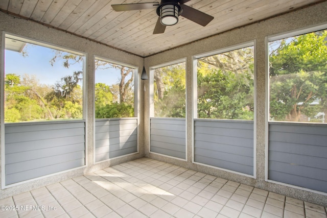 unfurnished sunroom with a wealth of natural light and a ceiling fan