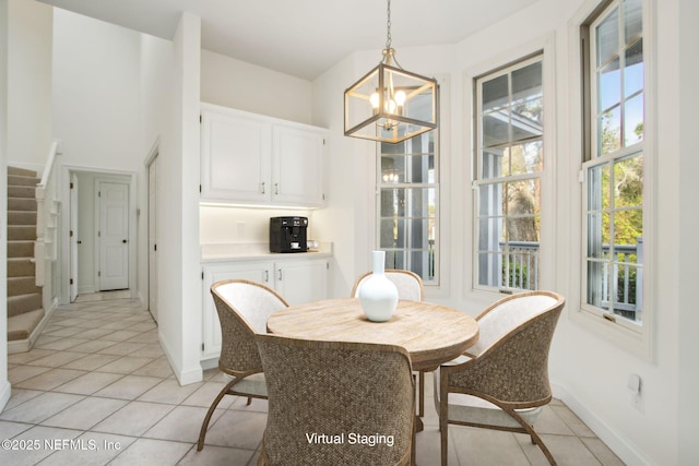 dining room with a wealth of natural light, an inviting chandelier, and light tile patterned floors