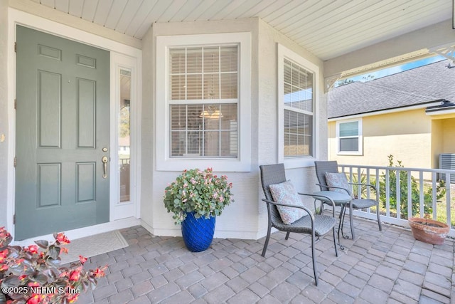 714 Copperhead Cir, Saint Augustine, FL 32092 - view of exterior entry featuring stucco siding, covered porch, and a shingled roof