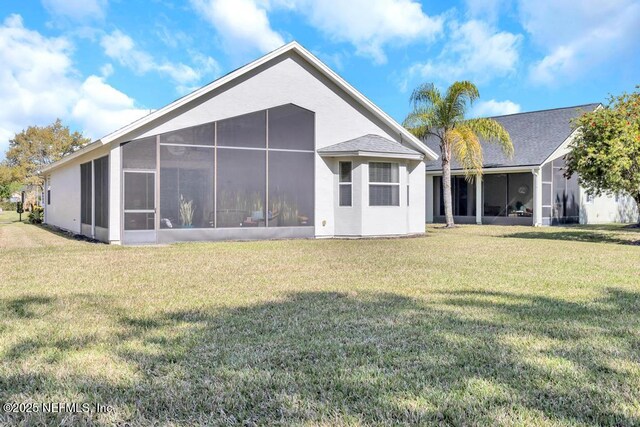 714 Copperhead Cir, Saint Augustine, FL 32092 - rear view of house with a lawn and a sunroom