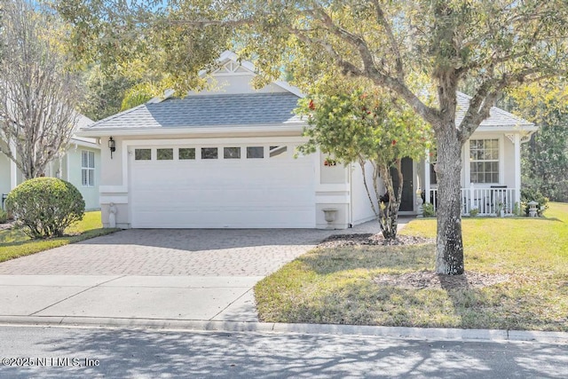 714 Copperhead Cir, Saint Augustine, FL 32092 - view of front of property featuring stucco siding, a garage, a front lawn, and decorative driveway