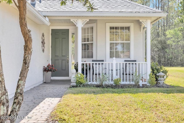 714 Copperhead Cir, Saint Augustine, FL 32092 - entrance to property featuring a shingled roof, stucco siding, covered porch, and a yard