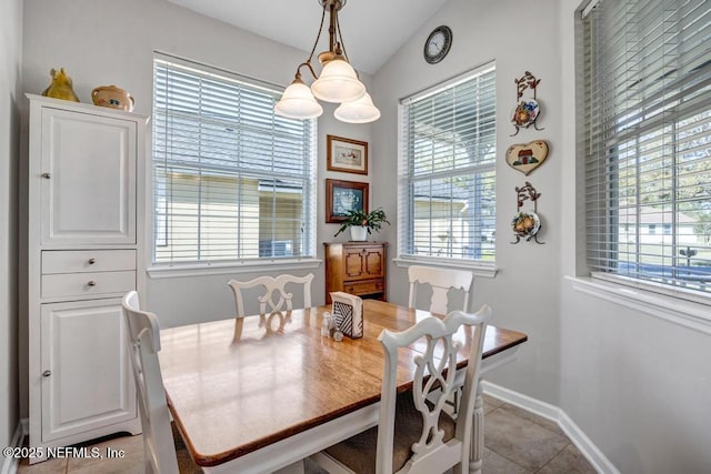 714 Copperhead Cir, Saint Augustine, FL 32092 - dining space with light tile patterned flooring, baseboards, and lofted ceiling
