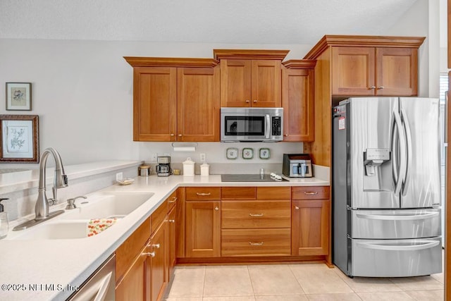 714 Copperhead Cir, Saint Augustine, FL 32092 - kitchen with light tile patterned flooring, light countertops, brown cabinets, stainless steel appliances, and a sink