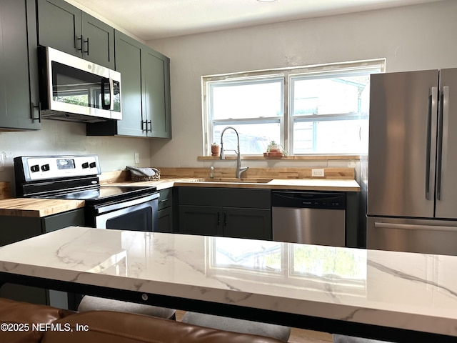 2118 Detroit St, Jacksonville, FL 32254 - kitchen featuring stainless steel appliances, a sink, and light stone countertops