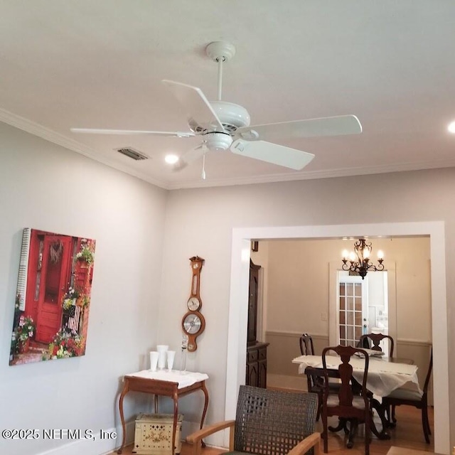 dining area with ornamental molding, recessed lighting, visible vents, and ceiling fan with notable chandelier