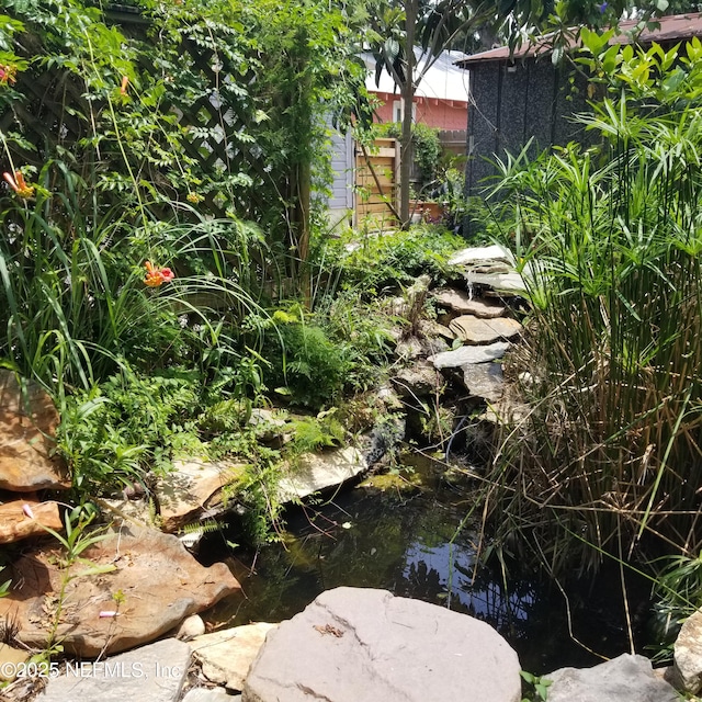 9 E Ln, Saint Augustine, FL 32084 - view of yard featuring a small pond