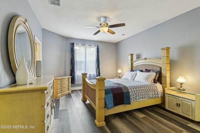 535 Hedgewood Dr, Saint Augustine, FL 32092 - bedroom with dark wood finished floors, a textured ceiling, visible vents, and a ceiling fan